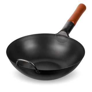 Black wok with a wooden handle on a white background